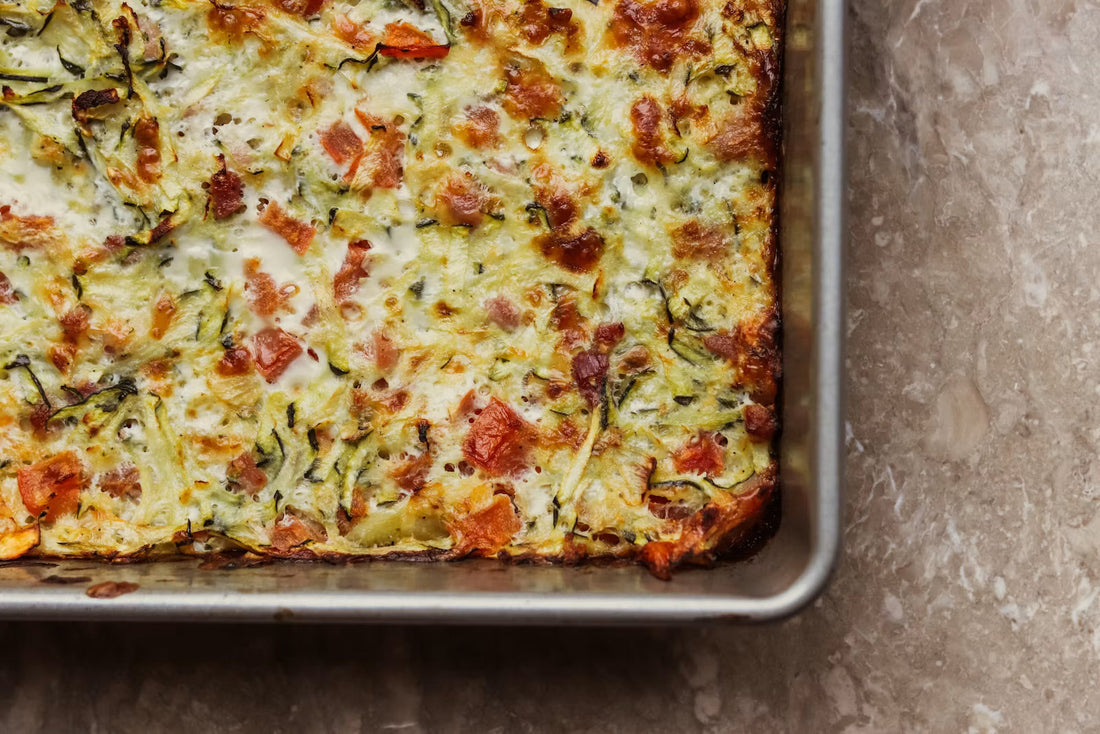 Baked sausage breakfast casserole in a metal pan, seen from above