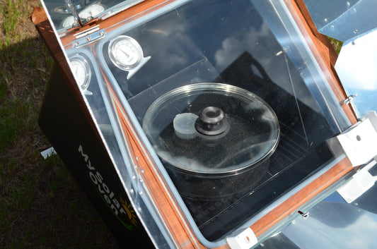 Covered pot of water pasteurizing inside My Solar Oven